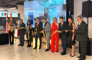 Image of nine people cutting the ribbon at the opening of the Mexico Office for Economic Development and Tourism