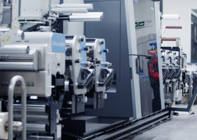 Worker stands at large technological looking machine