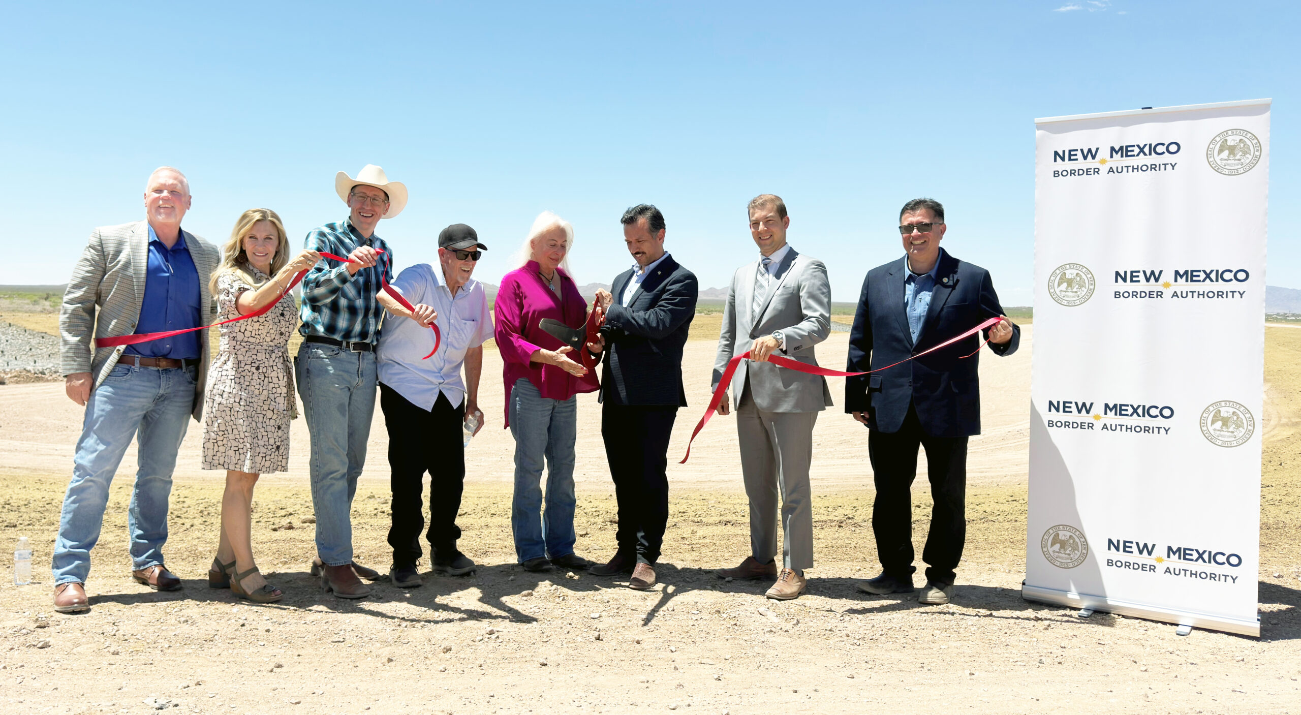 Image of officials in the desert with a cut ribbon