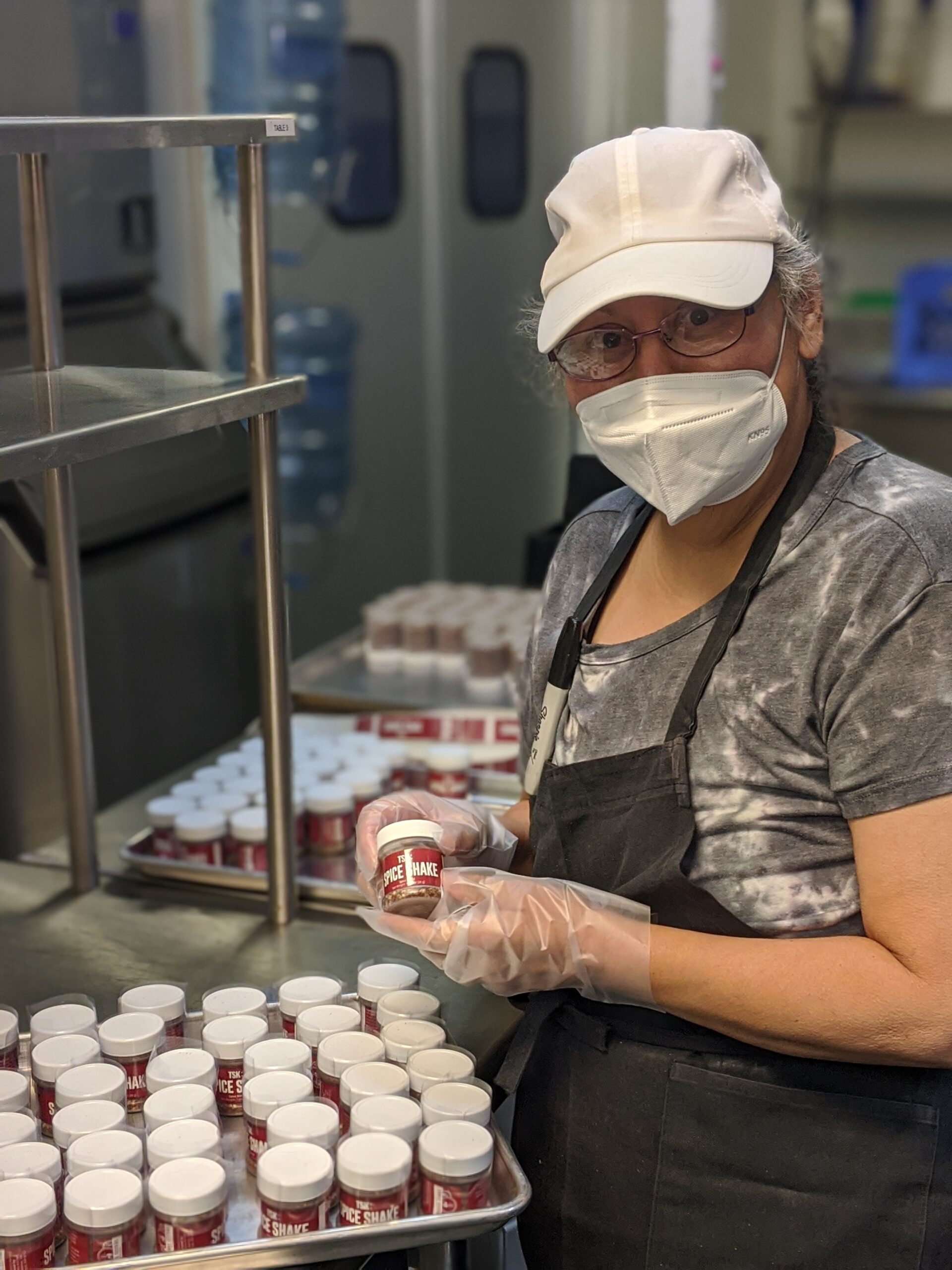 Kitchen worker prepares seasoning for the fresh granola